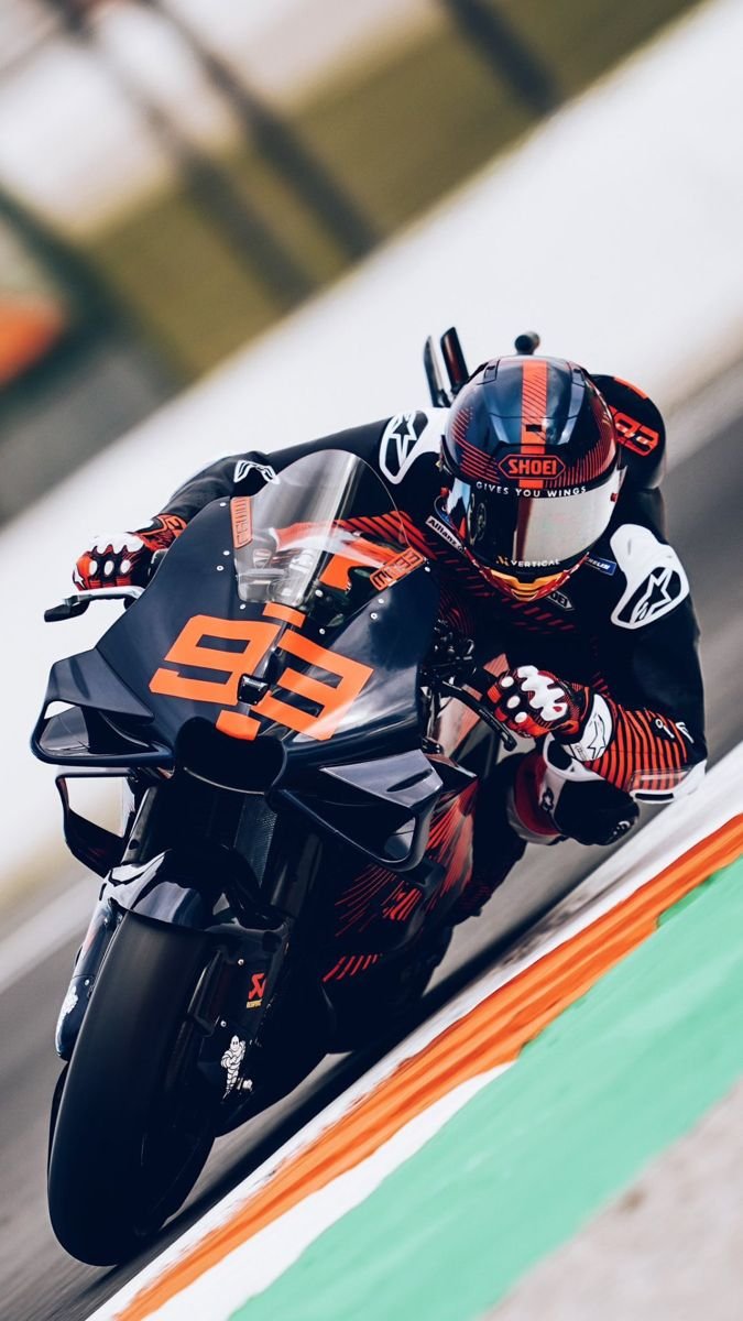 Red Bull Racing Driver Wearing A Branded Racing Suit And Helmet Against A Fiery
