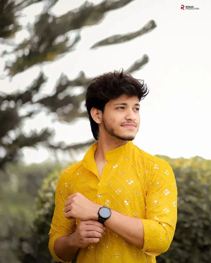 Candid Outdoor Portrait of Young Indian Man in Yellow Embroidered Kurta